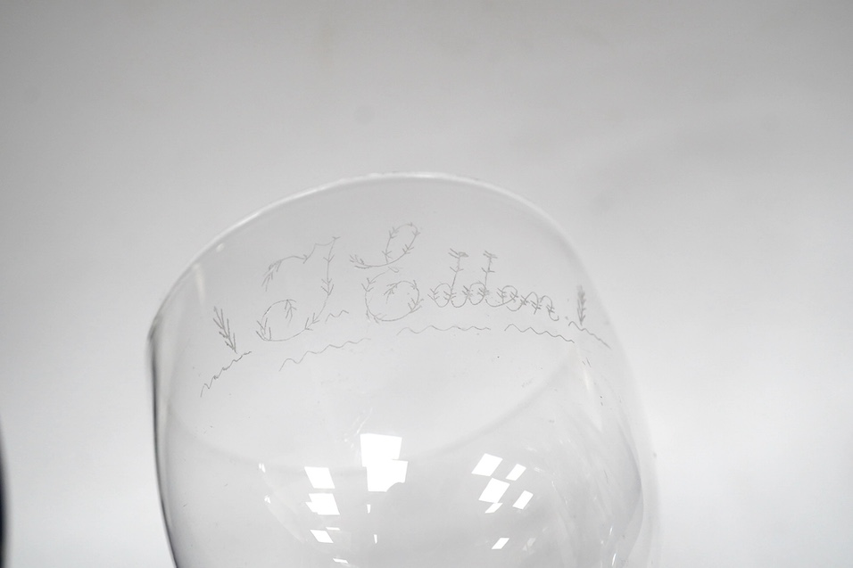 A DSOT stem goblet, circa 1765, with a cup shaped bowl, diamond point engraved ‘J Edden’and a facet stem wine glass, circa 1770, the round funnel bowl engraved with fruiting vines a chrysanthemum and a moth, 15.3cm and 1